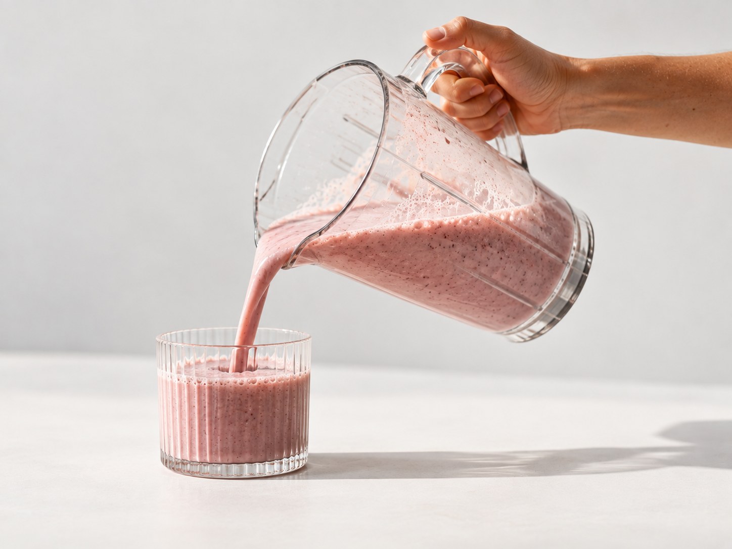Nalévání připraveného proteinového nápoje Powerlogy Whey Protein Berries do sklenice