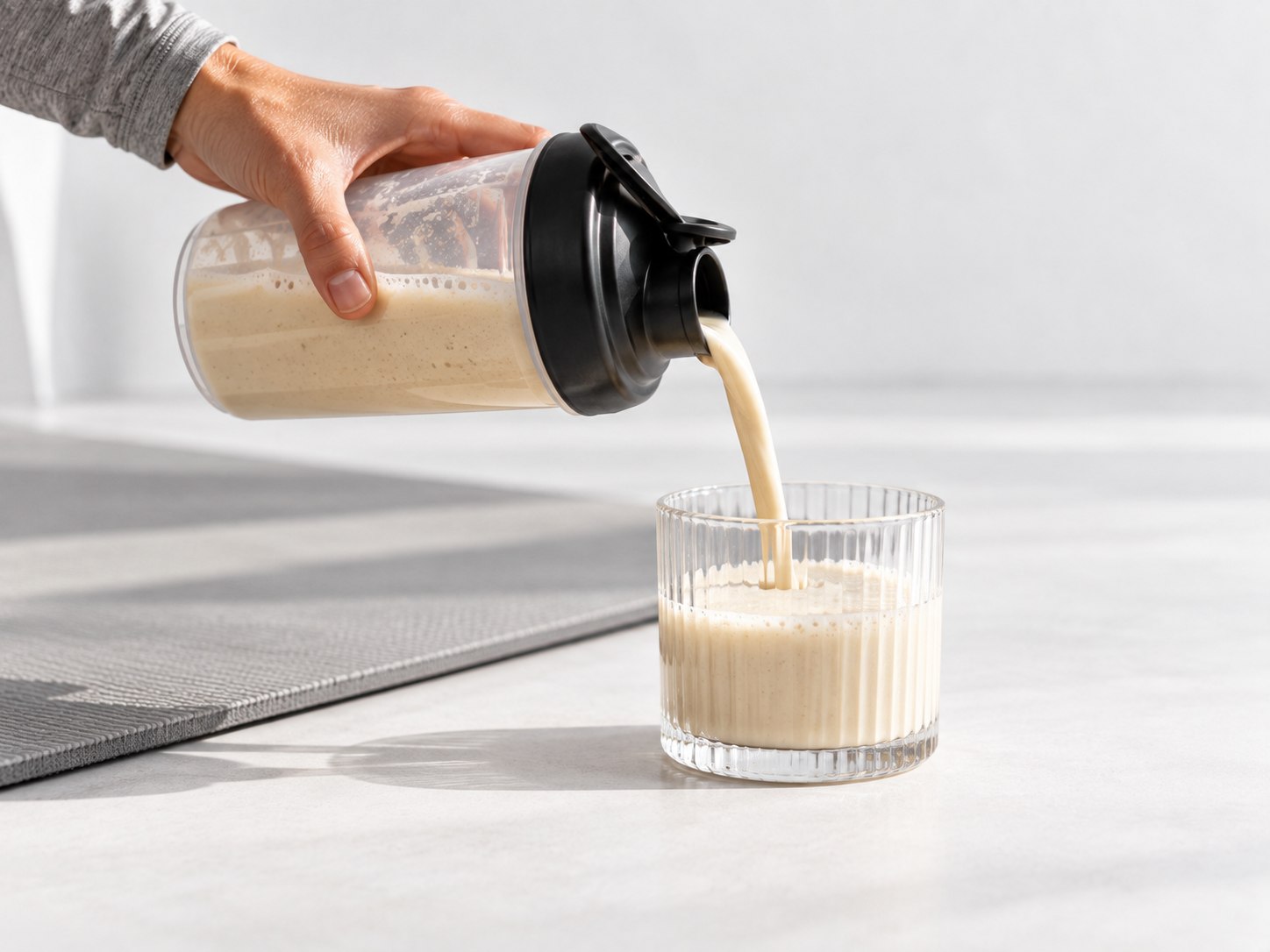 Der Powerlogy Upgraded Recovery Protein Coconut & Almond Shake wird nach dem Training ins Glas gegossen